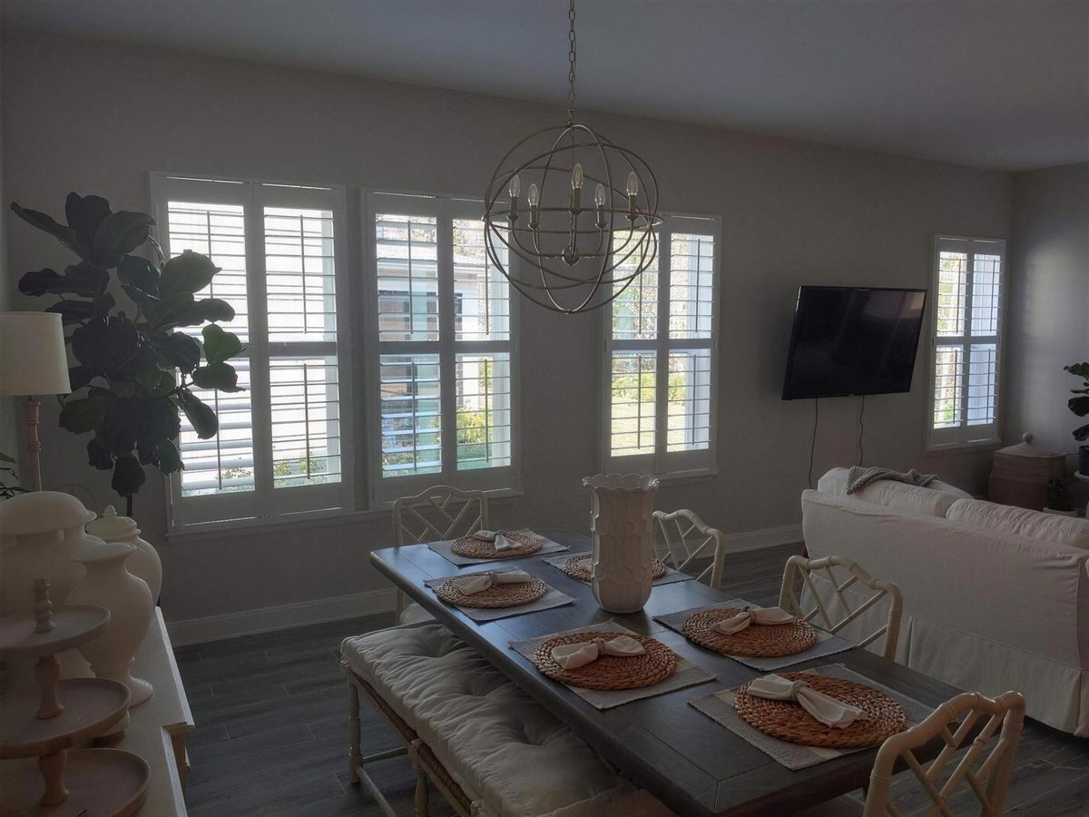 Custom white plantation shutters in a Jacksonville dining room
