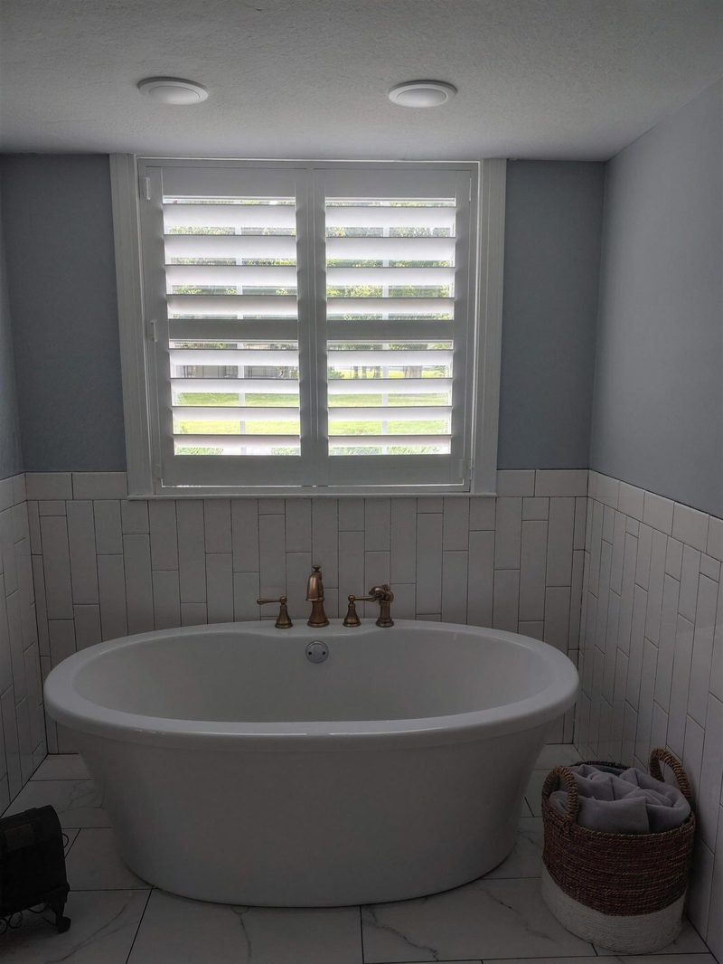 Arched shutter over garden tub