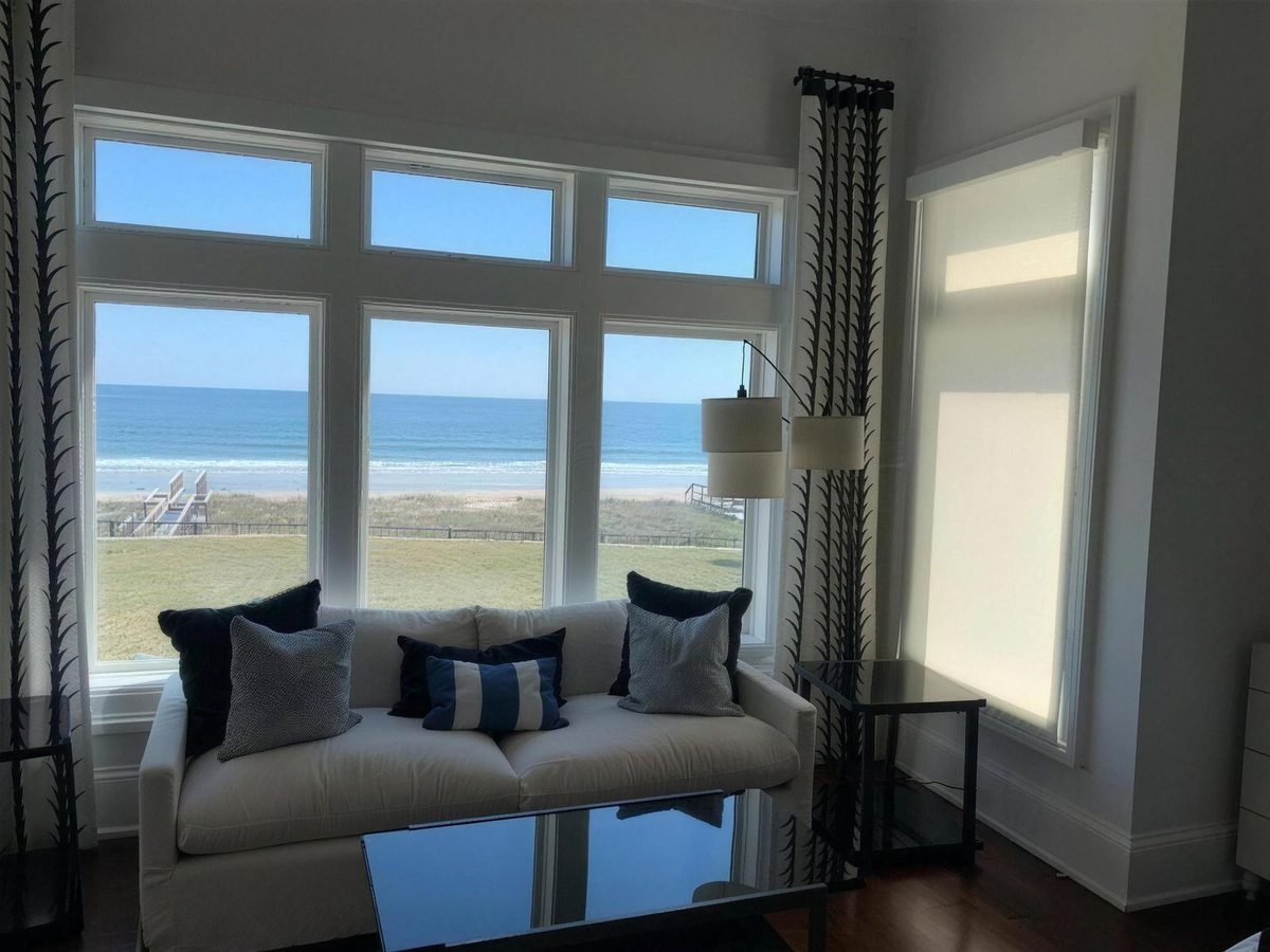 Roller shades filtering glare in an oceanfront Jacksonville Beach living room