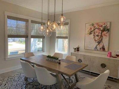 Dining room with woven shades under pendant lighting