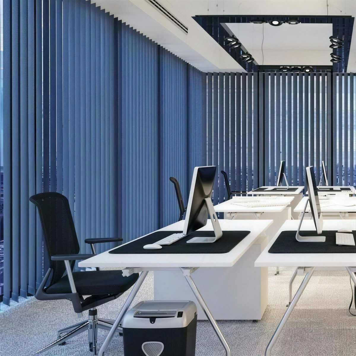Office with custom vertical fabric panels on large windows