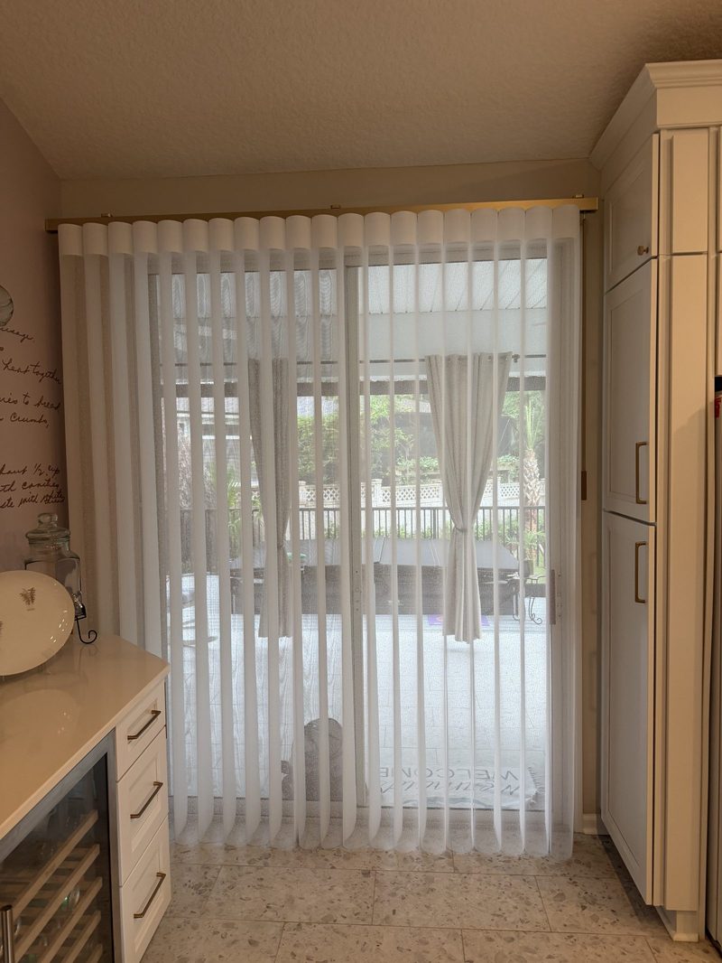 Vertical blinds over a sliding glass door