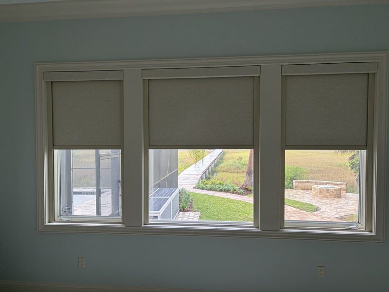 Roller shades across three windows