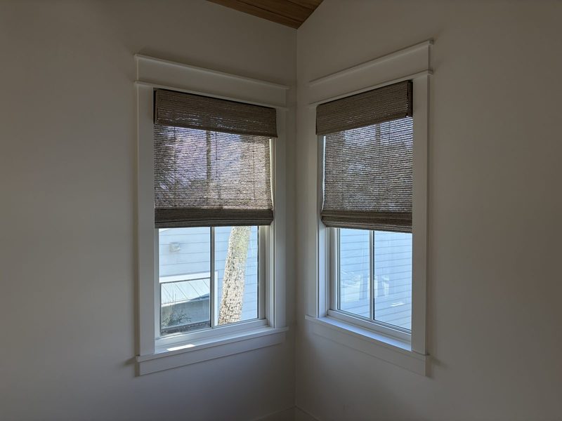 Woven wood shades on corner windows