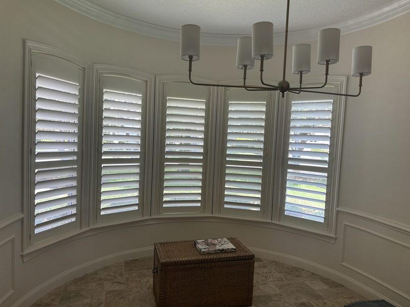 Plantation shutters around a curved bay window