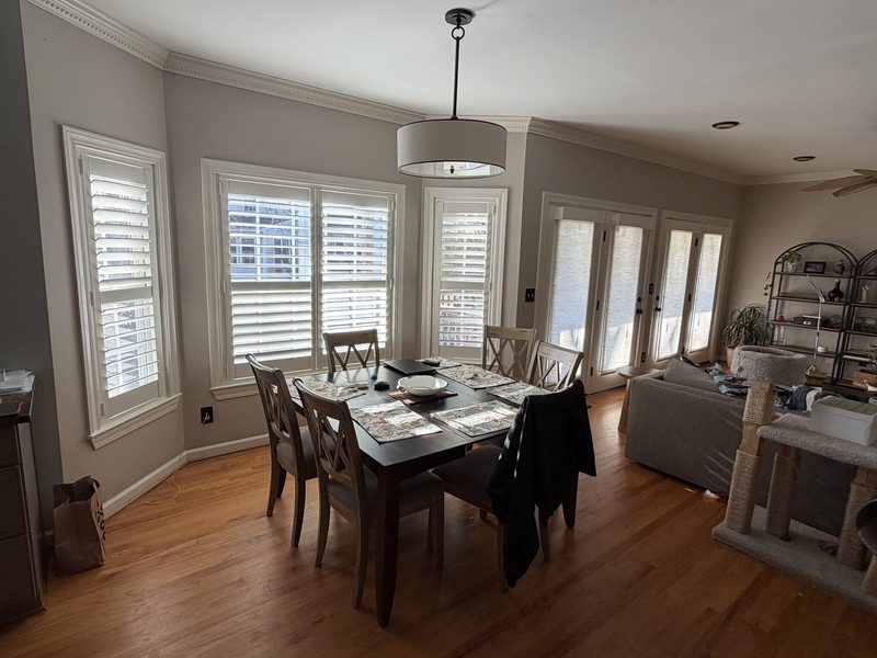 Plantation shutters in a dining room bay